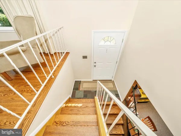 a view of a staircase with white walls and a floor to ceiling window
