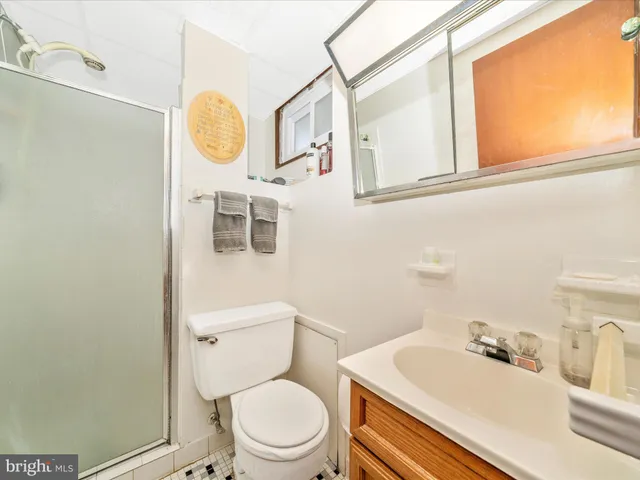 a balcony with wooden floor table and chairs