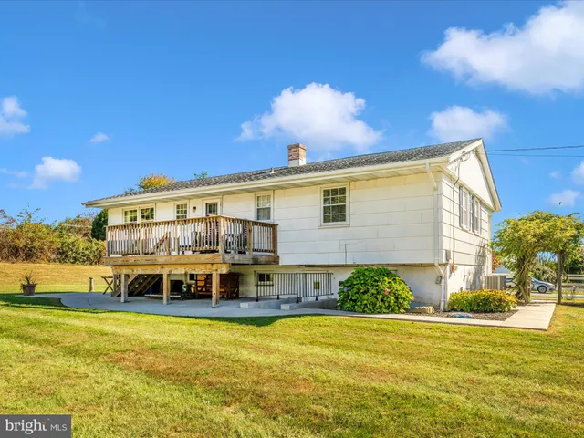 a swimming pool with outdoor seating and yard