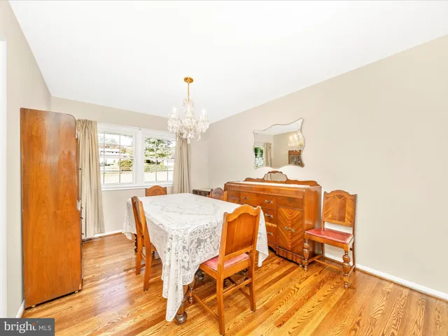 a living room with dining room and wooden floor