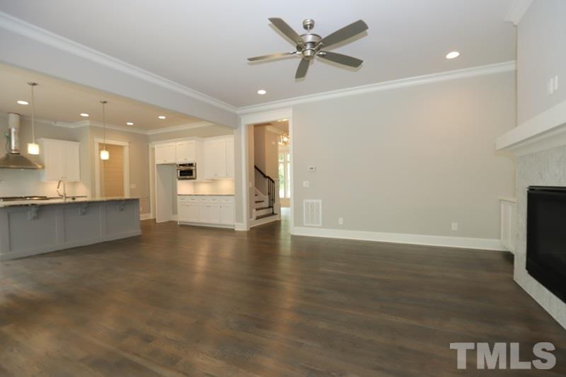 7200 Grist Mill Road Raleigh, NC 27615 - Photo 3 of 25 a view of an empty room with a window and wooden floor