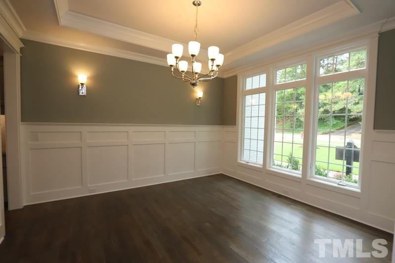 7200 Grist Mill Road Raleigh, NC 27615 - Photo 8 of 25 a view of an empty room with wooden floor and a window