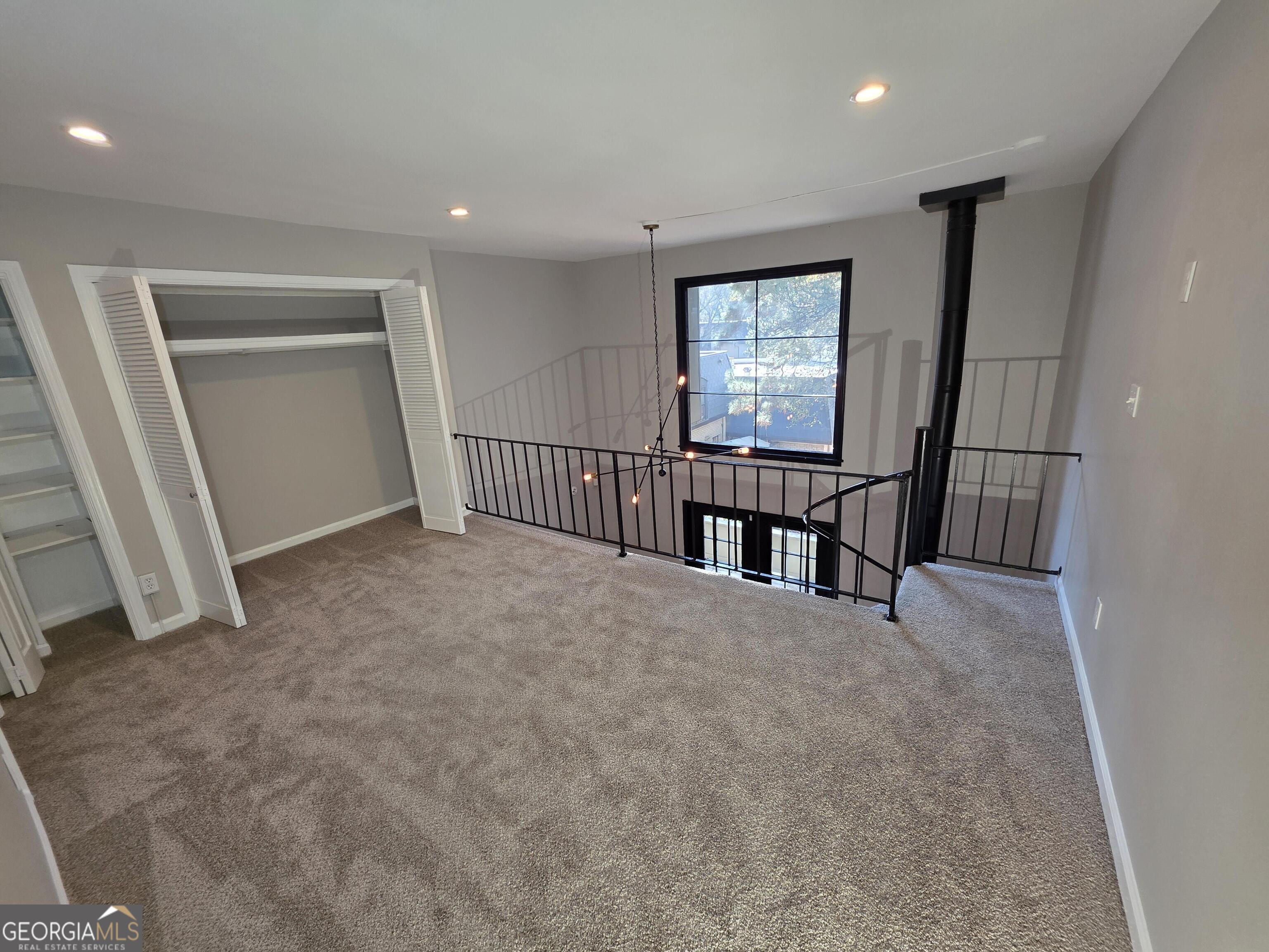 123 Elysian Way Northwest Atlanta, GA 30327 - Photo 14 of 18 an empty room with windows and stairs