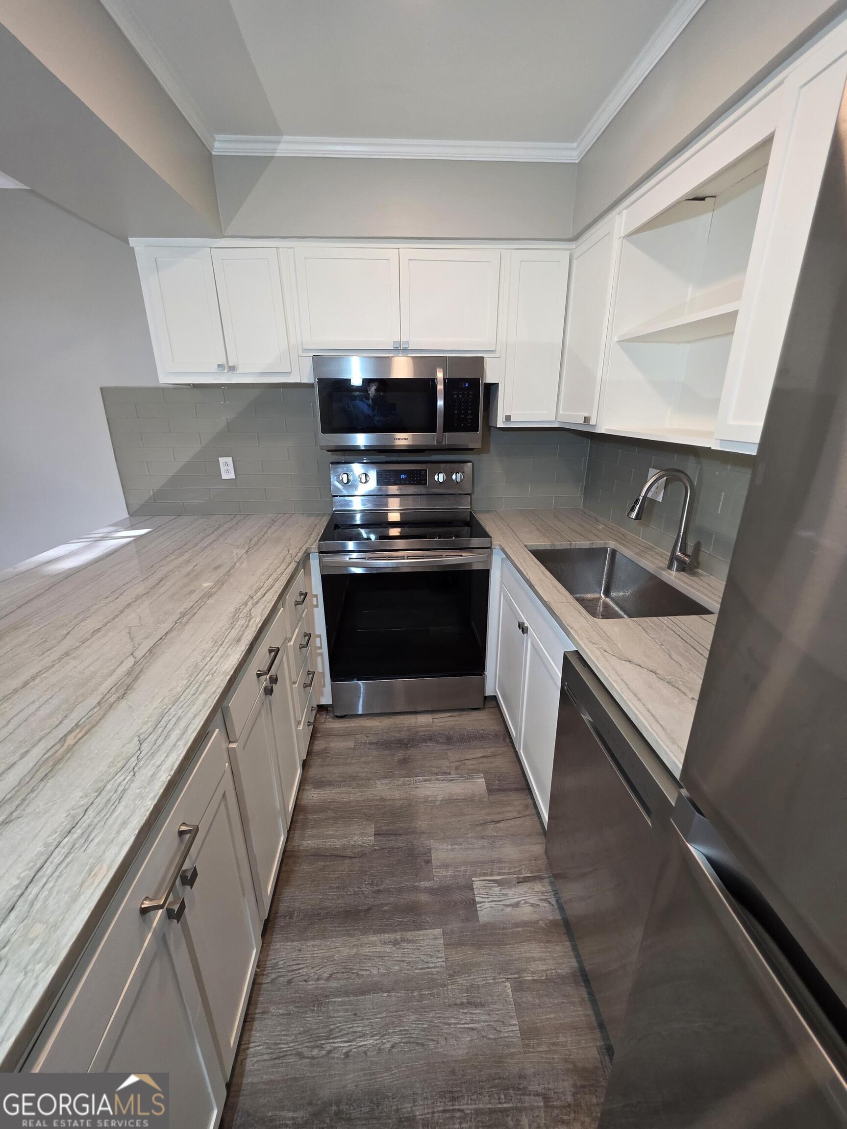 123 Elysian Way Northwest Atlanta, GA 30327 - Photo 7 of 18 a kitchen with granite countertop a sink and stove top oven