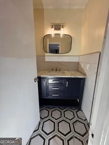 a bathroom with a sink and a mirror
