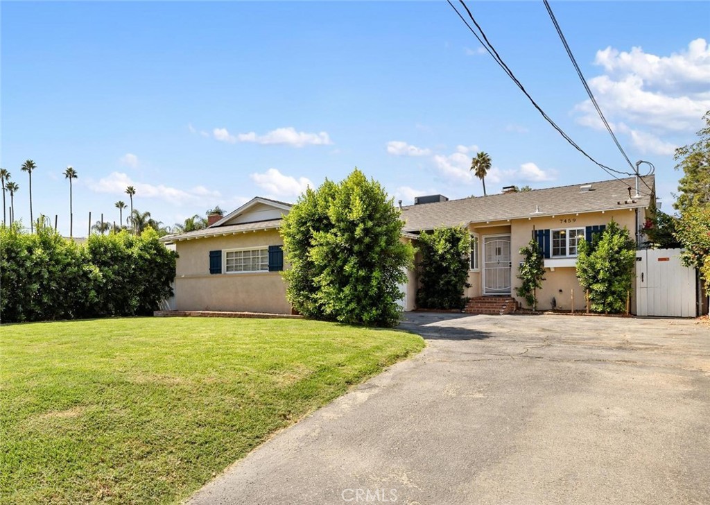 a view of a house with a yard and a garage