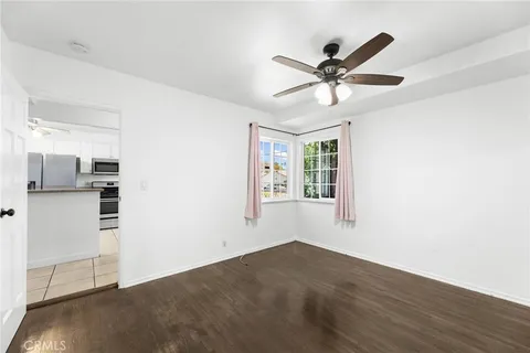 a view of a livingroom with a ceiling fan and window
