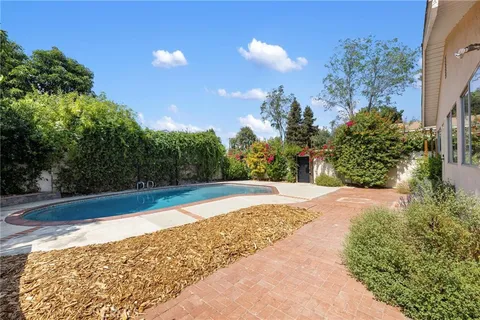 a view of a yard with large trees