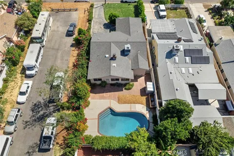 an aerial view of a house with yard swimming pool and lake view