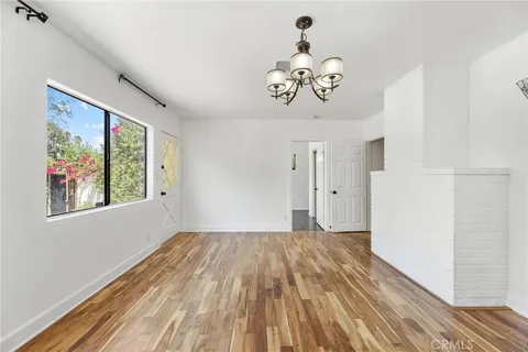 a view of a room with wooden floor and windows
