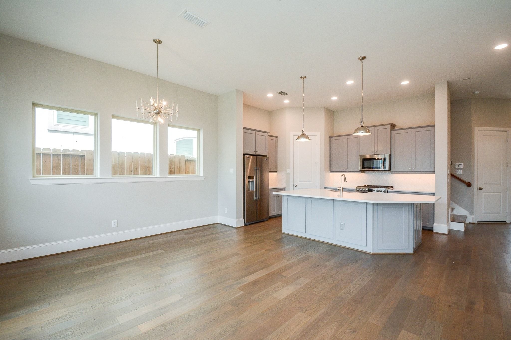 1407 Arkley Way Houston, TX 77055 - Photo 11 of 41 a large kitchen with a large counter top a sink stainless steel appliances and cabinets