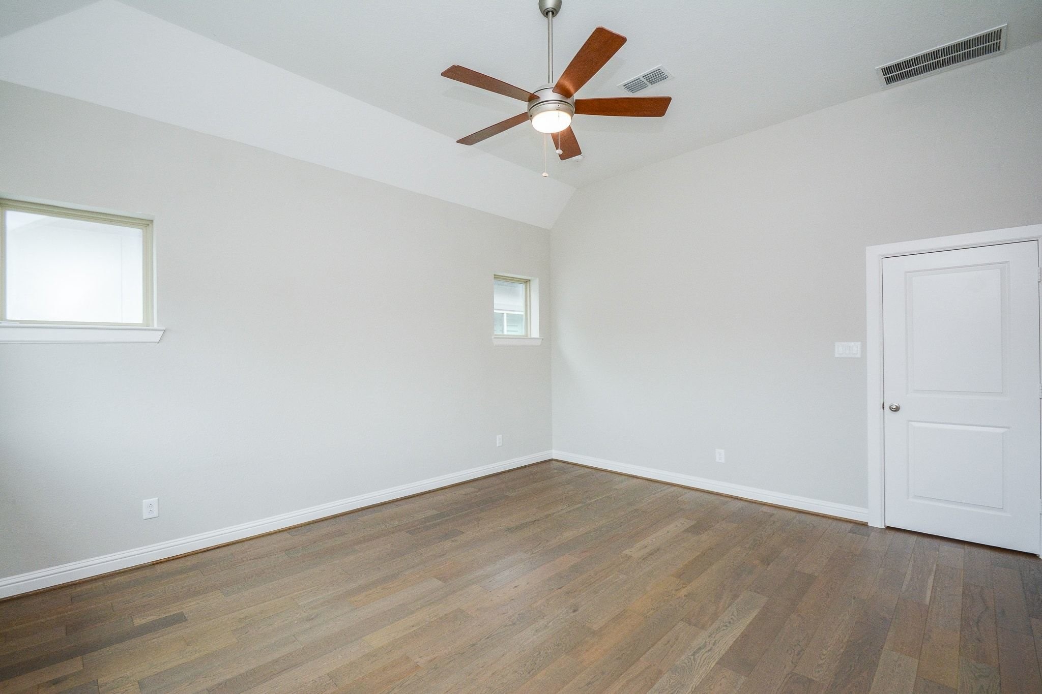 1407 Arkley Way Houston, TX 77055 - Photo 21 of 41 an empty room with wooden floor and a ceiling fan