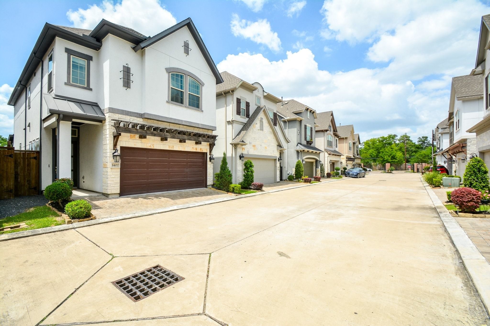 1407 Arkley Way Houston, TX 77055 - Photo 41 of 41 a view of a white house with a road and a yard