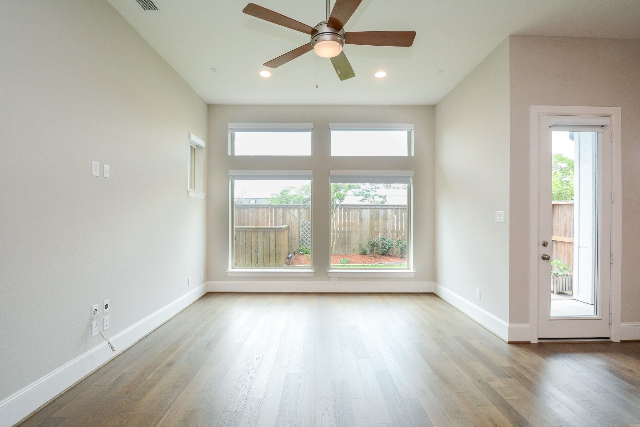 1407 Arkley Way Houston, TX 77055 - Photo 5 of 41 a view of an empty room with wooden floor and a window