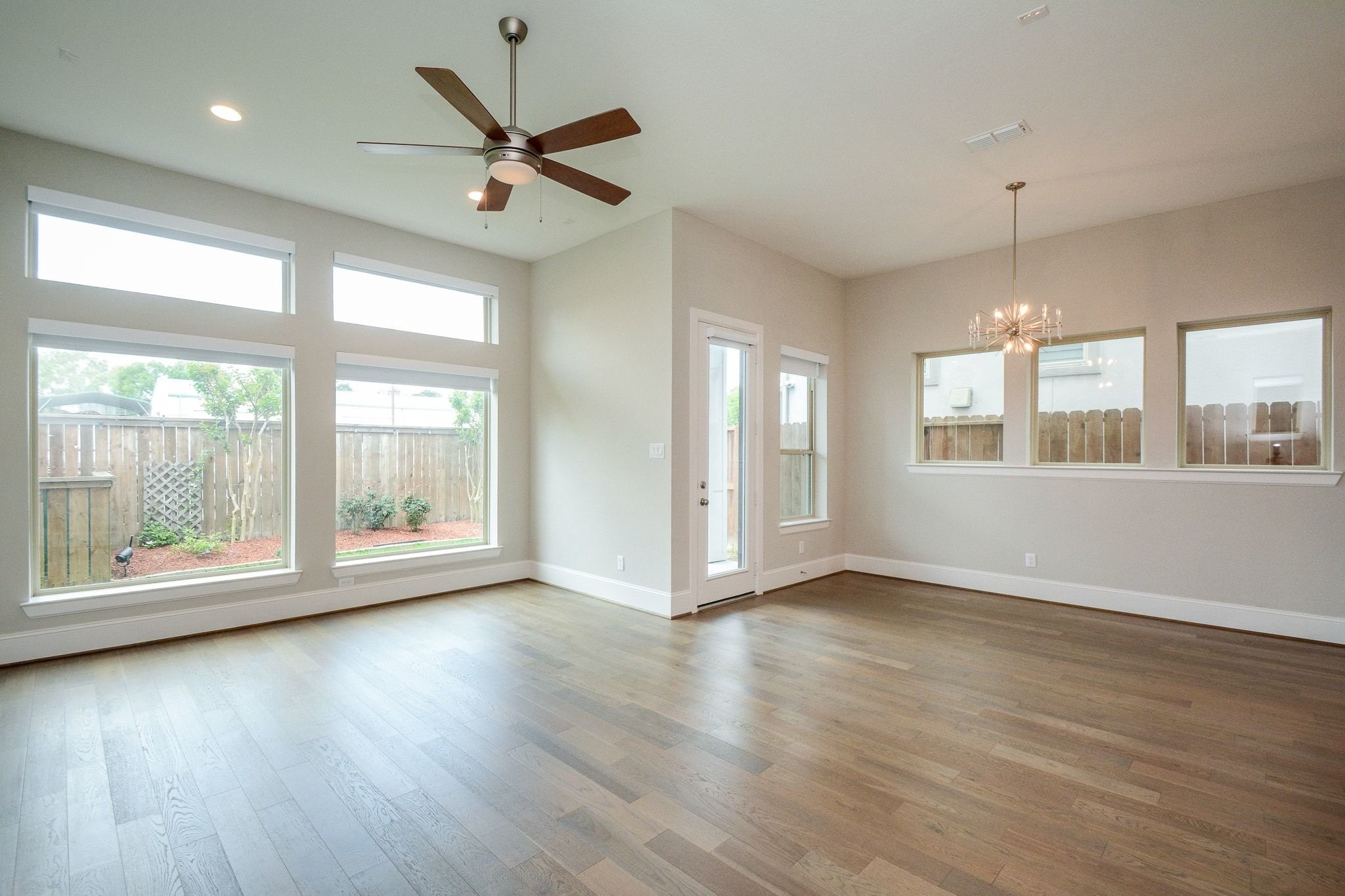1407 Arkley Way Houston, TX 77055 - Photo 8 of 41 a view of an empty room with a window and wooden floor