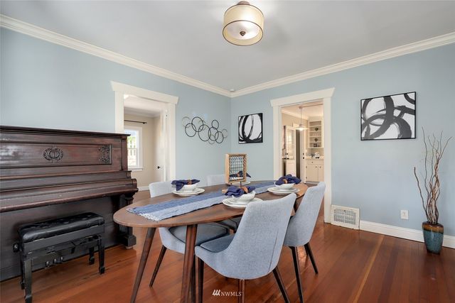 a view of a dining room with furniture and wooden floor