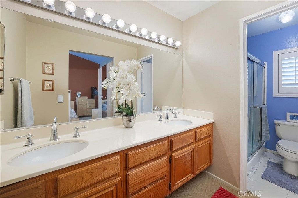 31347 Quail Valley Road Castaic, CA 91384 - Photo 18 of 41 a bathroom with a granite countertop double vanity sink mirror and toilet