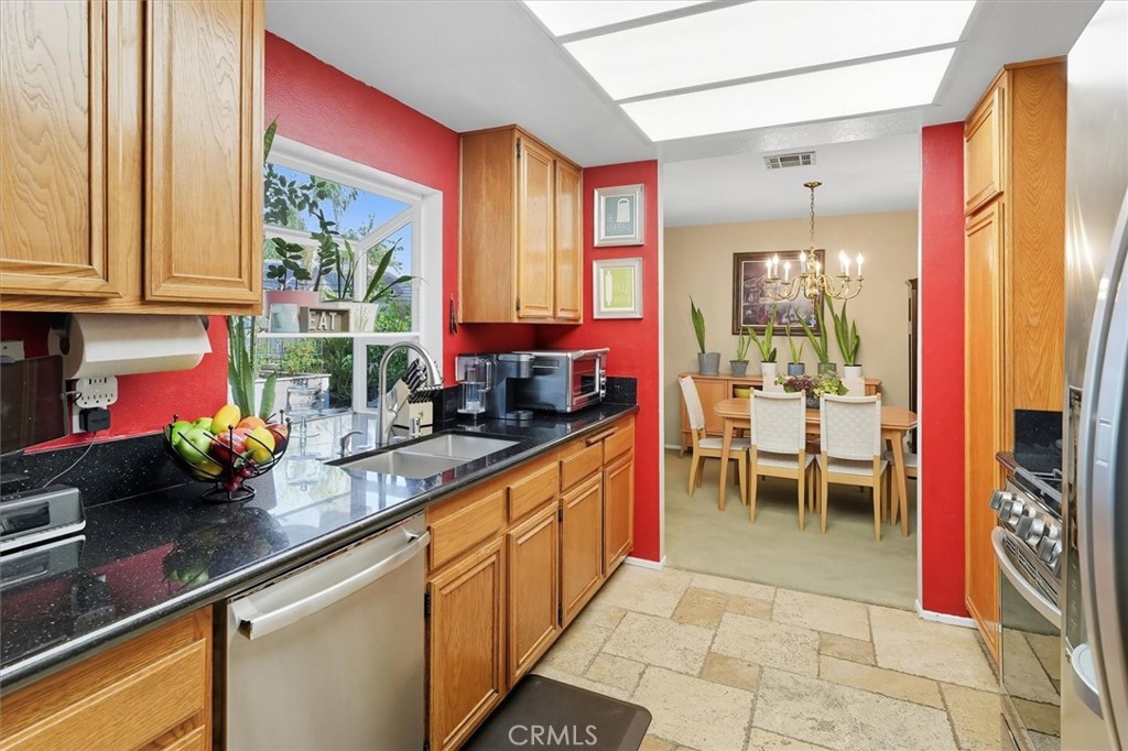 31347 Quail Valley Road Castaic, CA 91384 - Photo 10 of 41 a kitchen that has a lot of cabinets a sink and a window