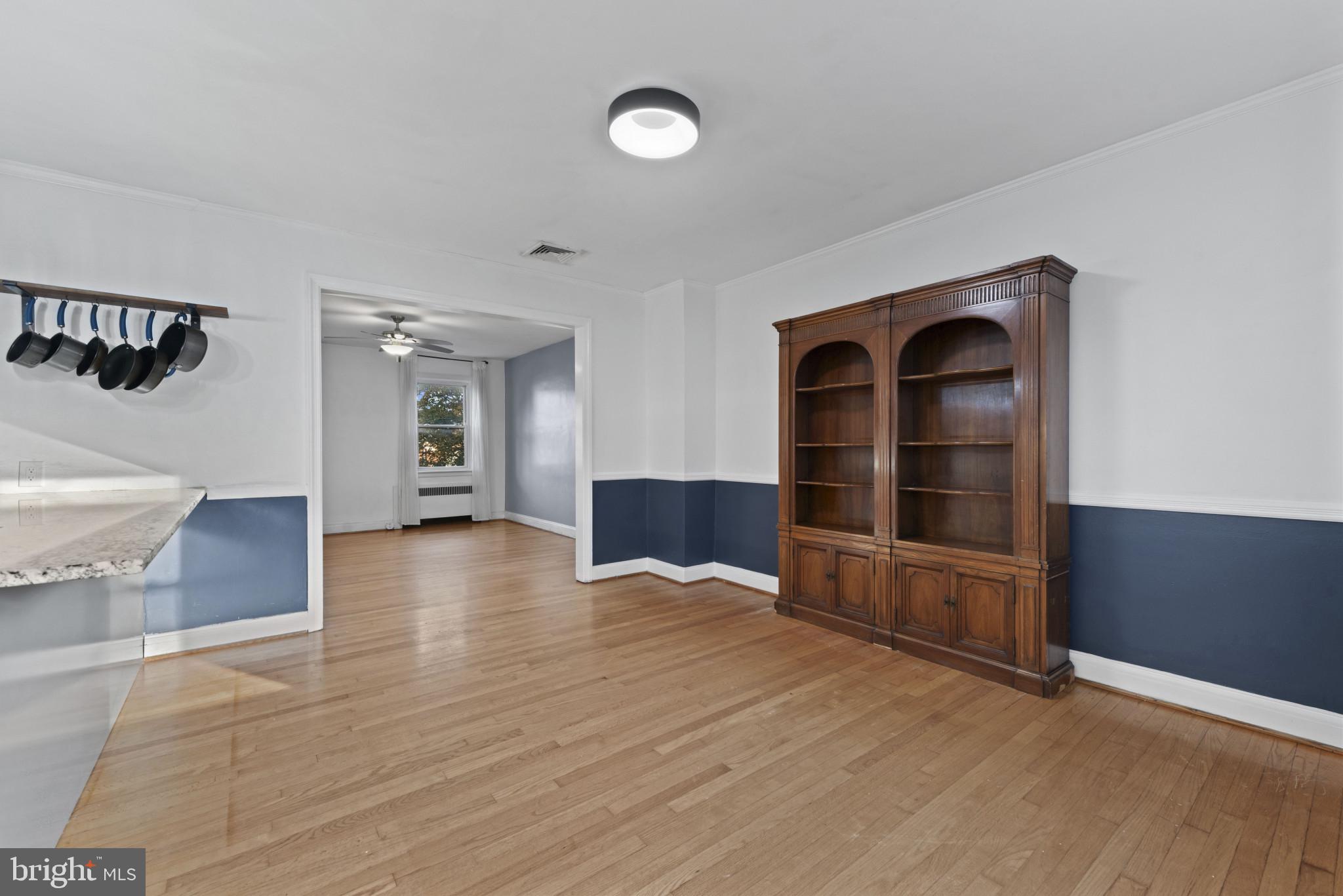 3712 Monterey Road Baltimore, MD 21218 - Photo 11 of 40 a view of empty room with wooden floor and fan