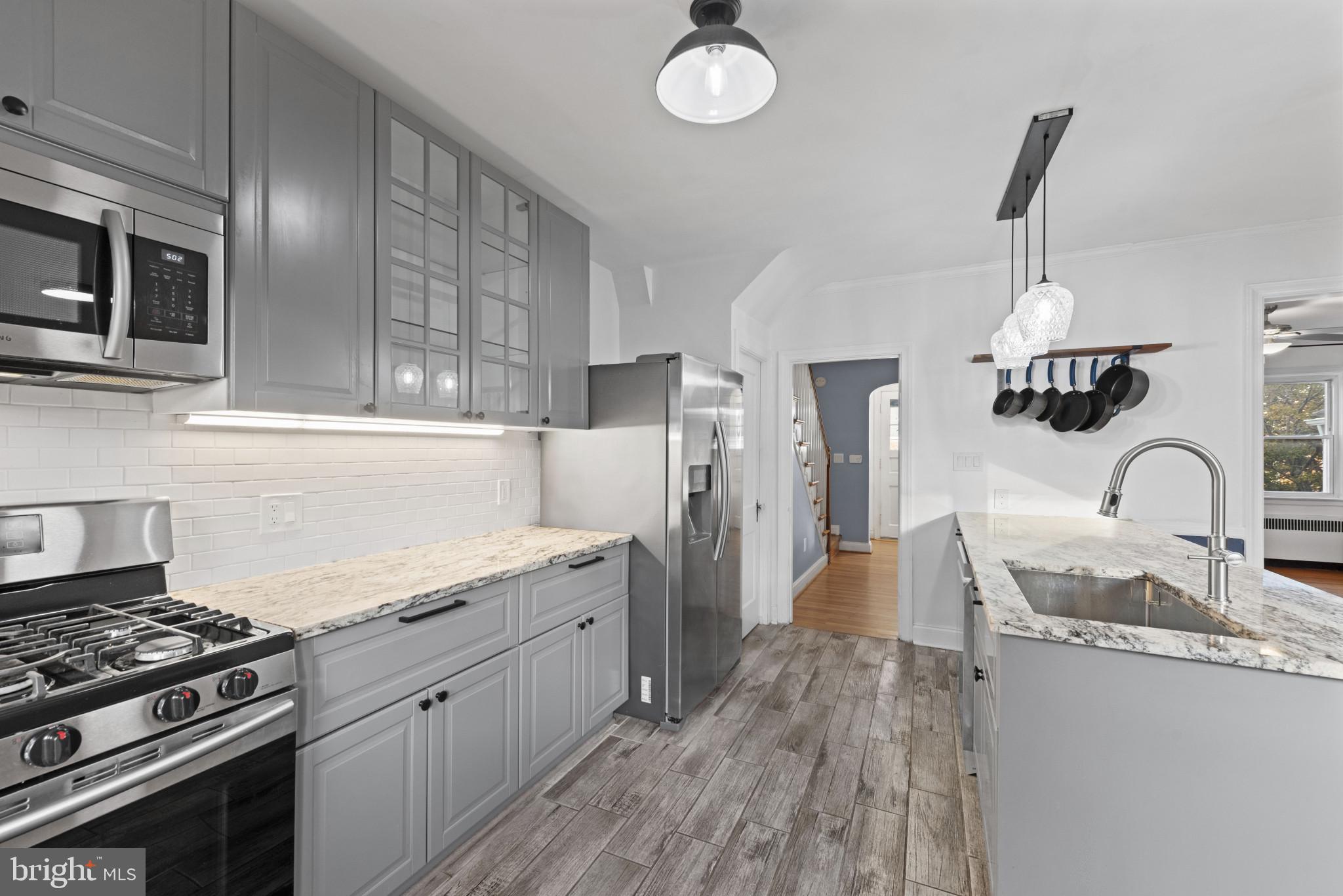 3712 Monterey Road Baltimore, MD 21218 - Photo 15 of 40 a kitchen with stainless steel appliances granite countertop a sink stove and refrigerator