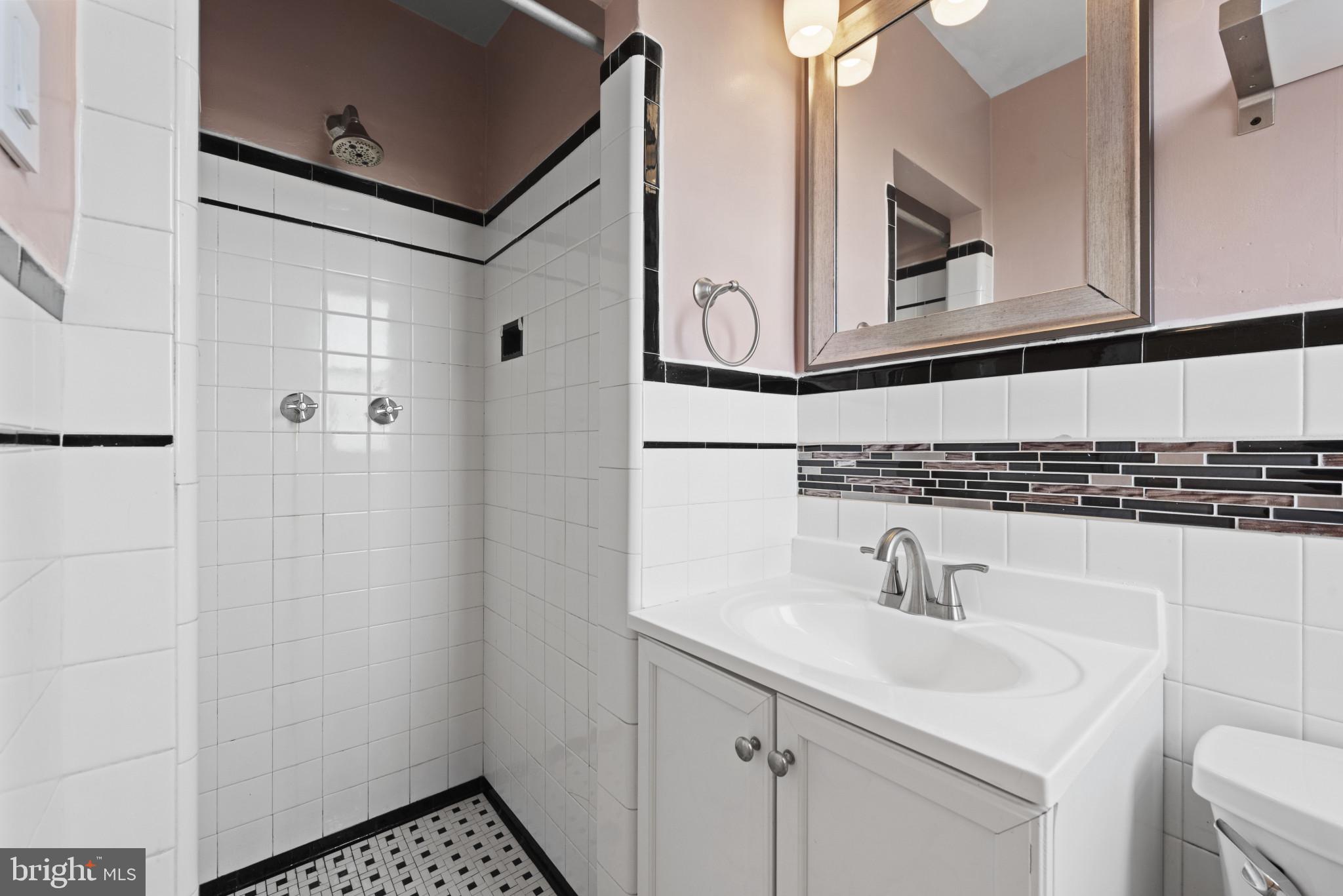 3712 Monterey Road Baltimore, MD 21218 - Photo 20 of 40 a bathroom with a sink and mirror