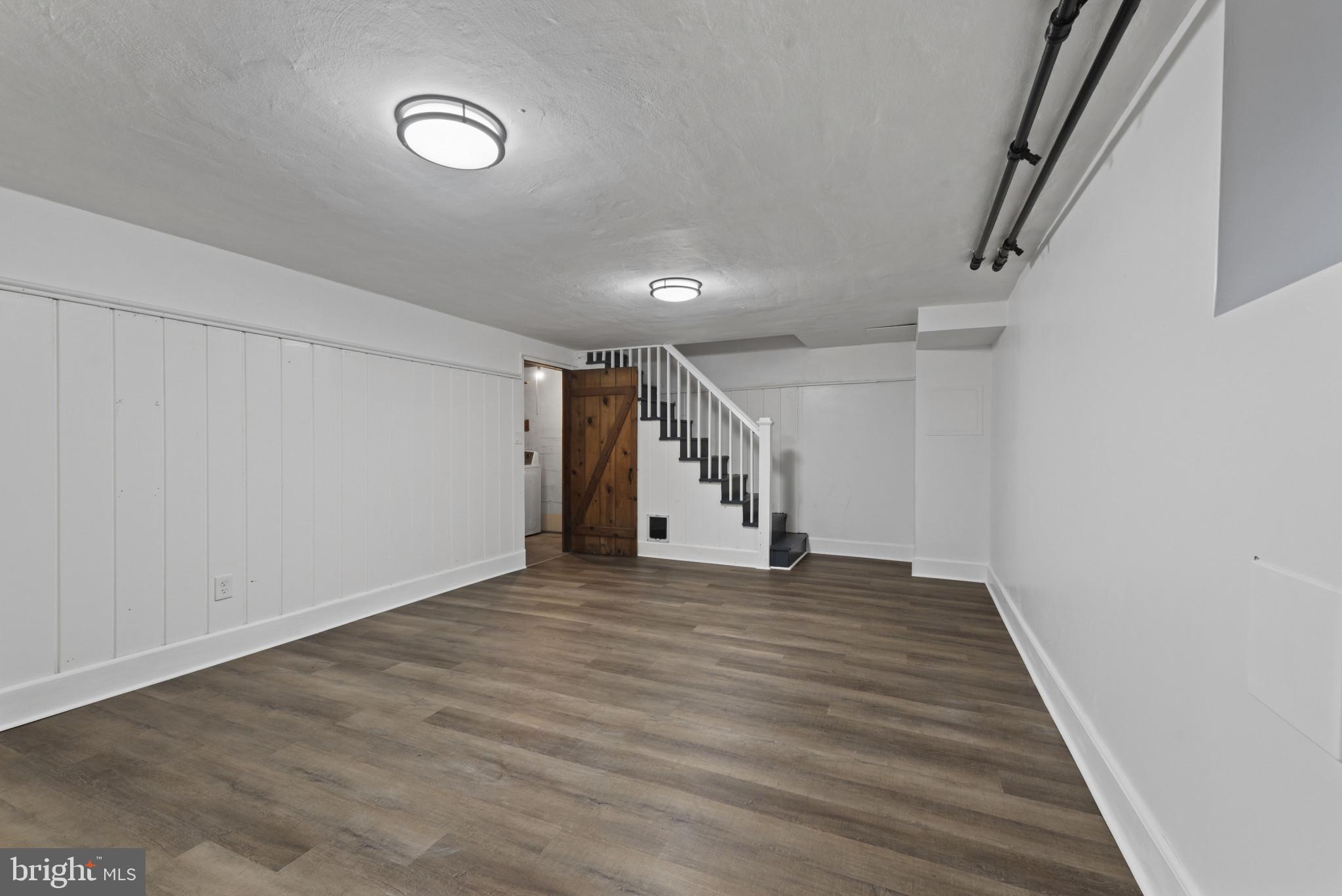 3712 Monterey Road Baltimore, MD 21218 - Photo 26 of 40 a view of an empty room with wooden floor