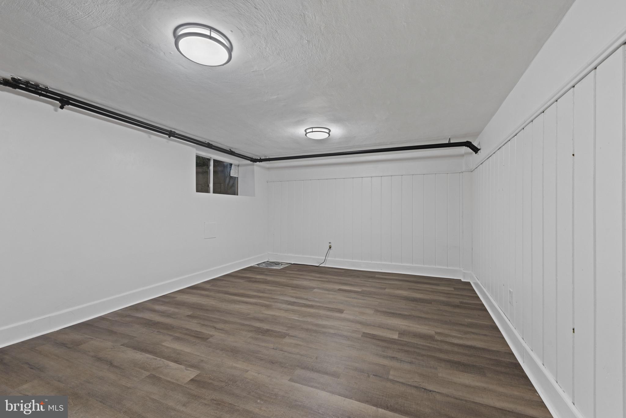 3712 Monterey Road Baltimore, MD 21218 - Photo 29 of 40 a view of an empty room with wooden floor