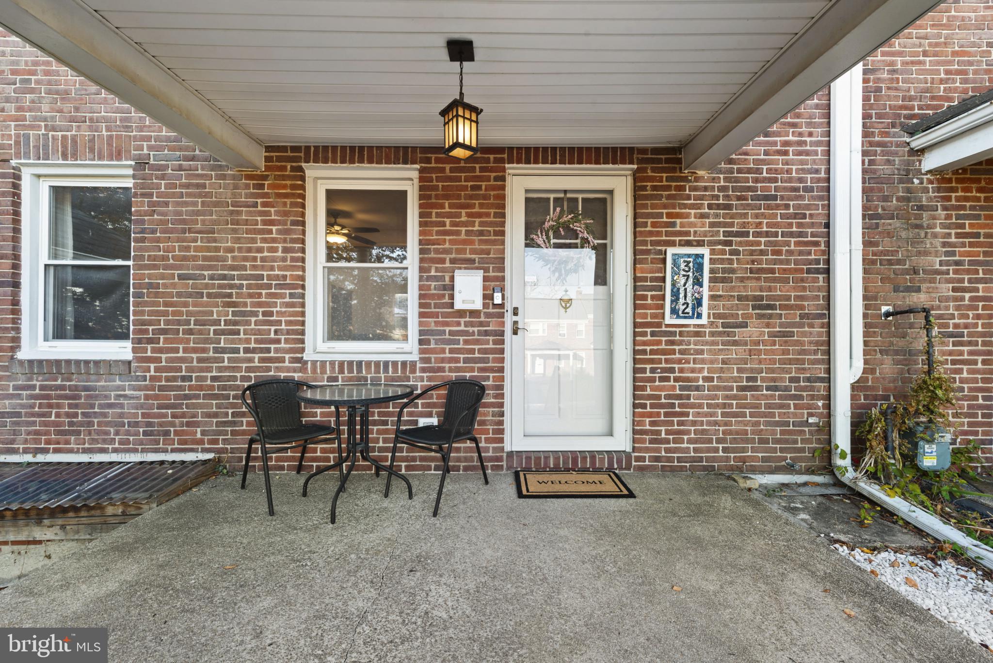 3712 Monterey Road Baltimore, MD 21218 - Photo 3 of 40 a backyard of a house with table and chairs