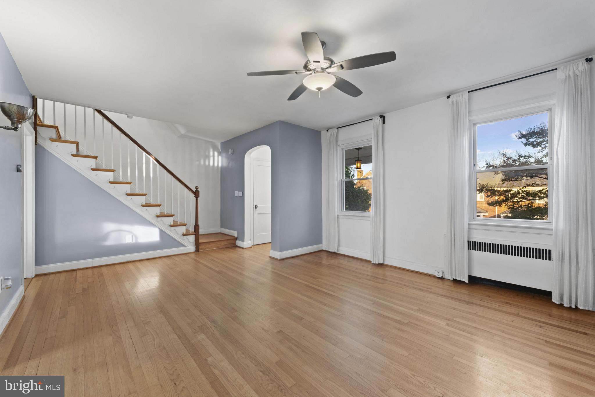 3712 Monterey Road Baltimore, MD 21218 - Photo 5 of 40 a view of an empty room with wooden floor and a window