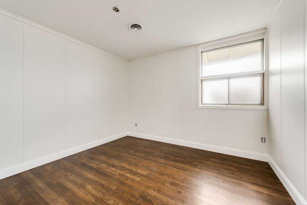 1815 Spring Avenue Carrollton, TX 75006 - Photo 12 of 20 an empty room with wooden floor and windows