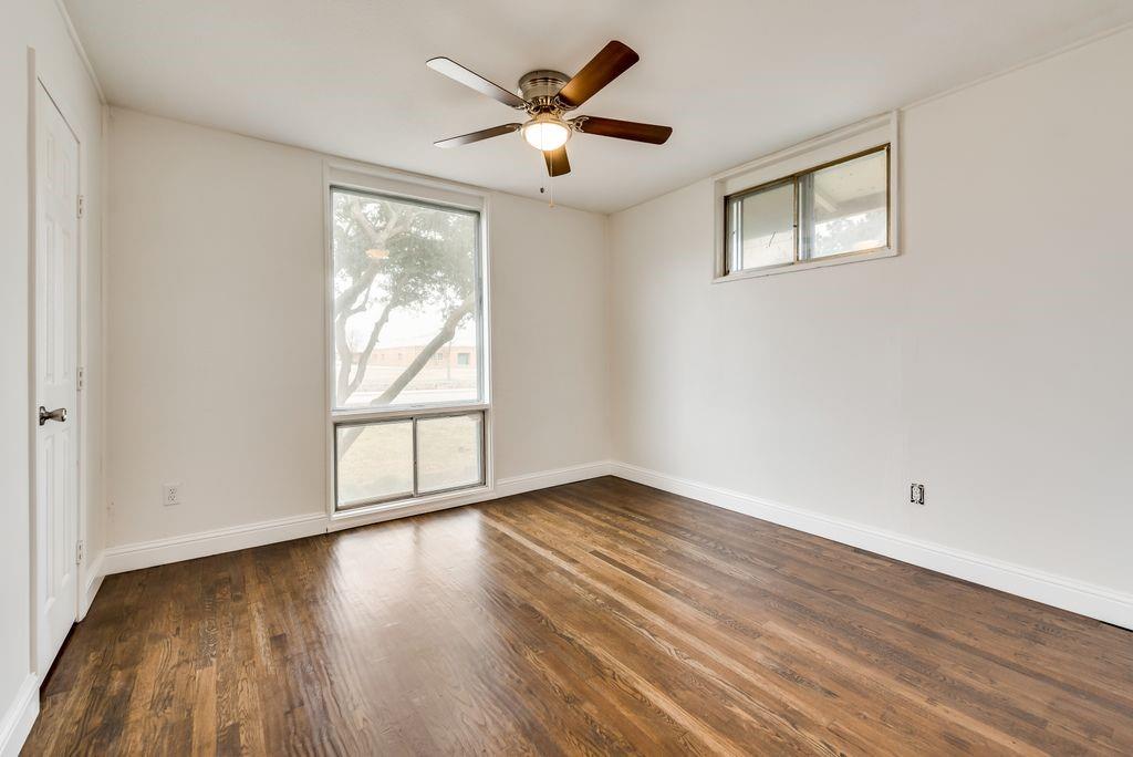 1815 Spring Avenue Carrollton, TX 75006 - Photo 15 of 20 an empty room with wooden floor and windows