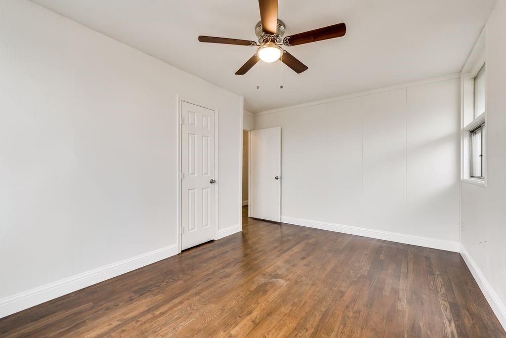 1815 Spring Avenue Carrollton, TX 75006 - Photo 16 of 20 an empty room with wooden floor fan and windows