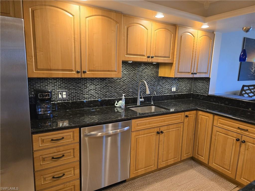 7119 Lakeridge View Court, Unit 302 Fort Myers, FL 33907 - Photo 15 of 44 a kitchen with granite countertop white cabinets and stainless steel appliances