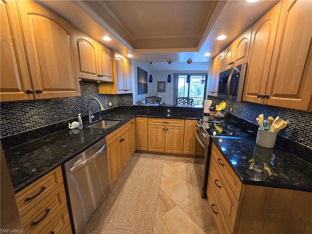7119 Lakeridge View Court, Unit 302 Fort Myers, FL 33907 - Photo 16 of 44 a kitchen with stainless steel appliances granite countertop sink stove refrigerator and cabinets