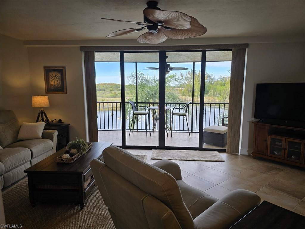 7119 Lakeridge View Court, Unit 302 Fort Myers, FL 33907 - Photo 20 of 44 a living room with furniture and a flat screen tv
