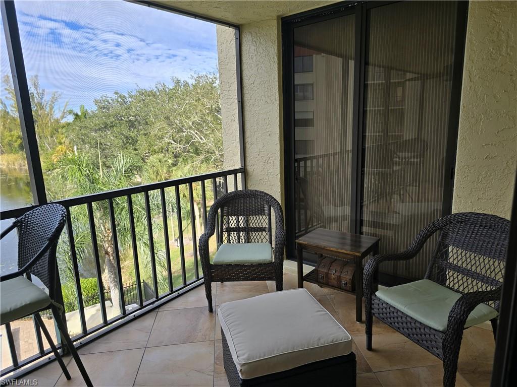 7119 Lakeridge View Court, Unit 302 Fort Myers, FL 33907 - Photo 25 of 44 a balcony with chairs and a table
