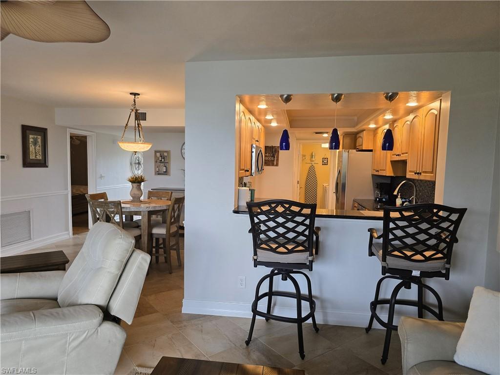 7119 Lakeridge View Court, Unit 302 Fort Myers, FL 33907 - Photo 28 of 44 a living room with furniture and wooden floor