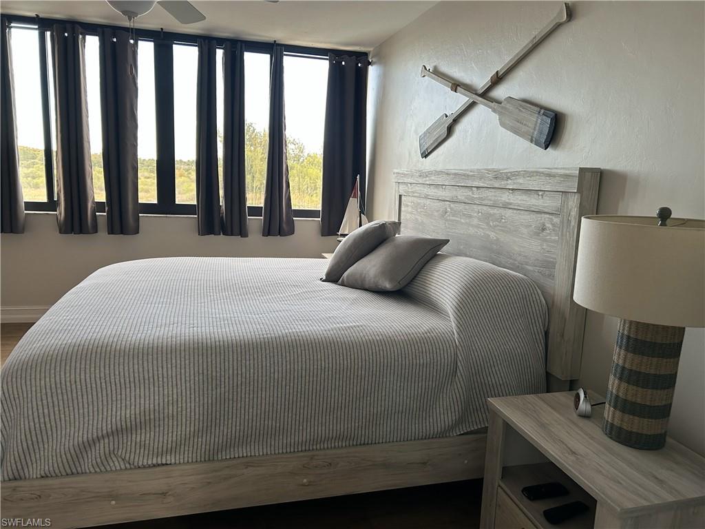 7119 Lakeridge View Court, Unit 302 Fort Myers, FL 33907 - Photo 31 of 44 a bedroom with a bed a mirror and desk