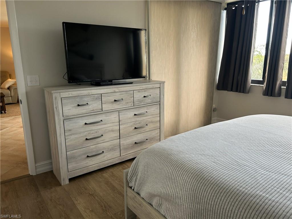 7119 Lakeridge View Court, Unit 302 Fort Myers, FL 33907 - Photo 33 of 44 a bedroom with a bed and a flat screen tv
