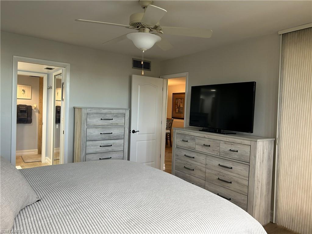 7119 Lakeridge View Court, Unit 302 Fort Myers, FL 33907 - Photo 34 of 44 a bedroom with a bed and a flat screen tv
