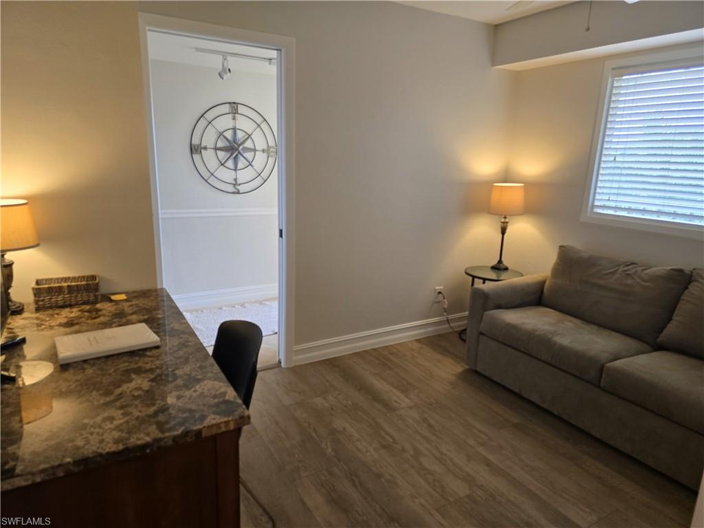 7119 Lakeridge View Court, Unit 302 Fort Myers, FL 33907 - Photo 4 of 44 a bedroom with a bed and a lamp on dresser