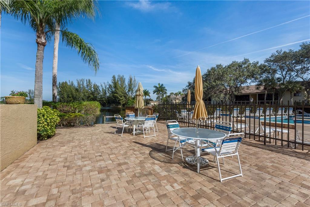 7119 Lakeridge View Court, Unit 302 Fort Myers, FL 33907 - Photo 41 of 44 a view of a patio with a table and chairs and potted plants