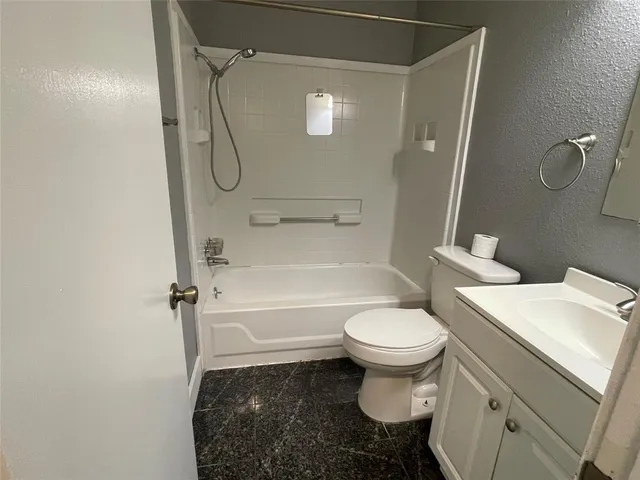 a bathroom with a toilet sink and a mirror