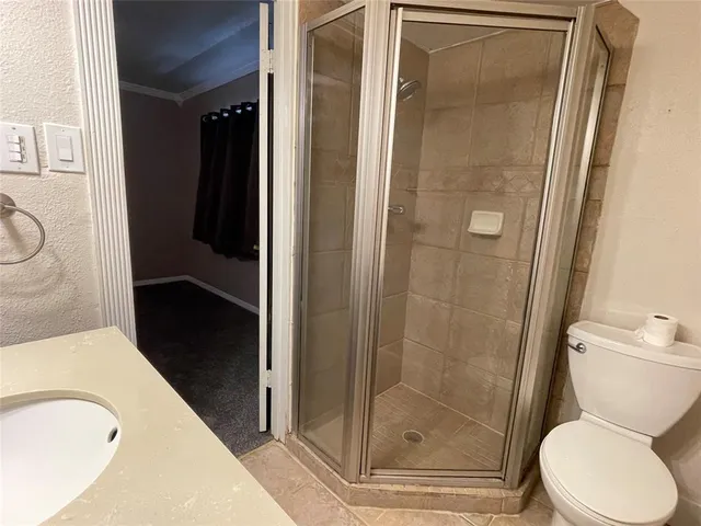 a bathroom with a toilet and a shower