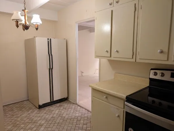 a kitchen with stainless steel appliances a refrigerator and a stove top oven