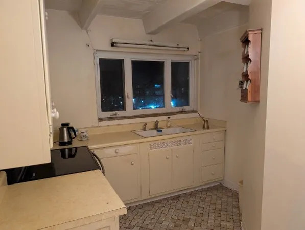 a room with a sink and cabinets
