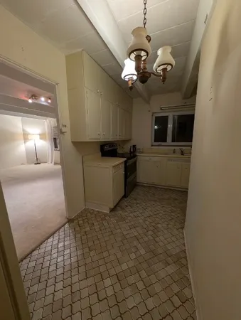 a kitchen with a sink and cabinets