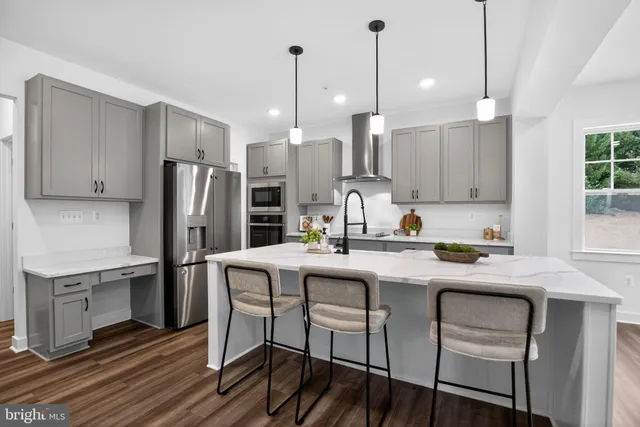 a kitchen with stainless steel appliances a sink stove and refrigerator