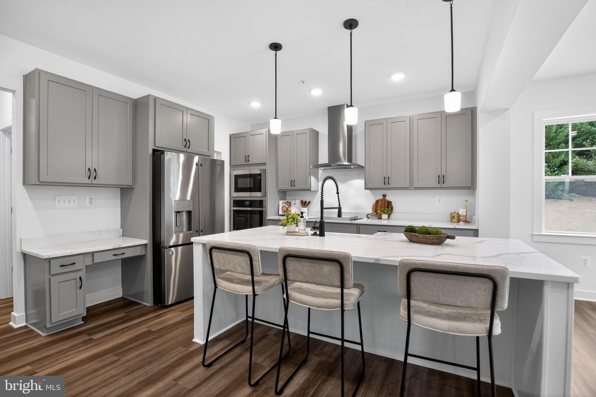 1975 Dares Beach Road Prince Frederick, MD 20678 - Photo 10 of 30 a kitchen with stainless steel appliances granite countertop a dining table chairs refrigerator and microwave