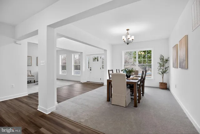 a view of a dining room with furniture and chandelier